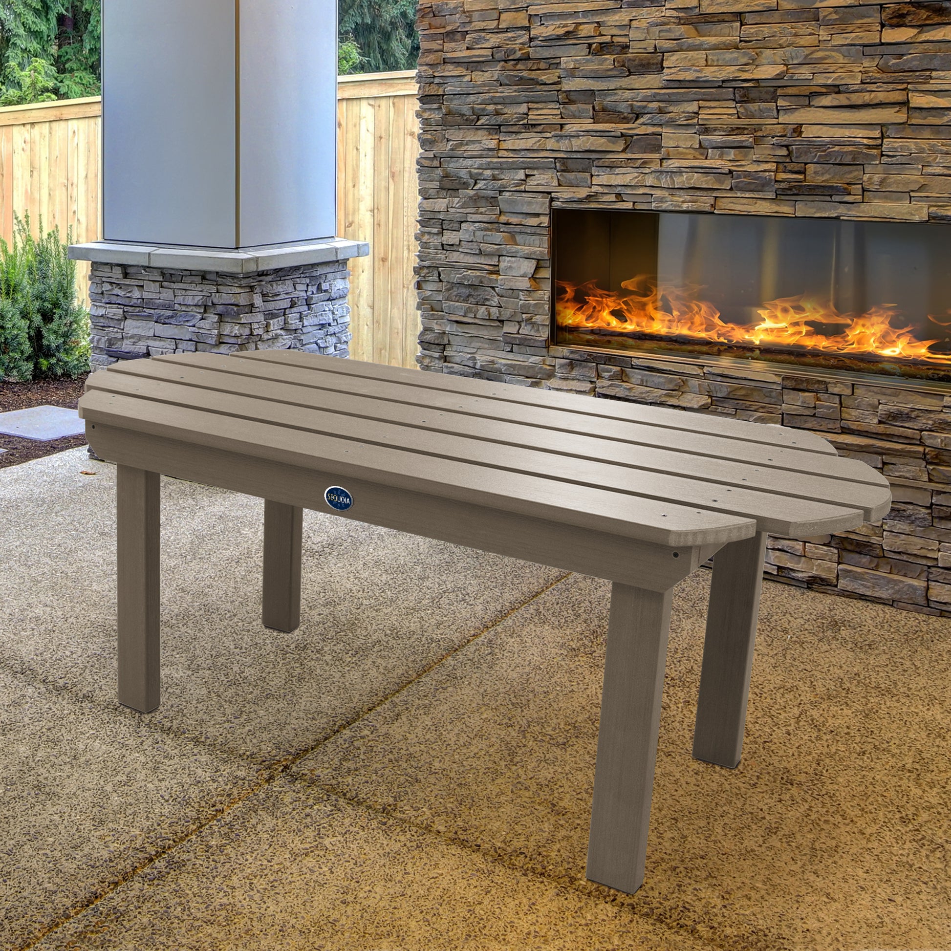 Light brown Lighthouse conversation table in front of outdoor fireplace 