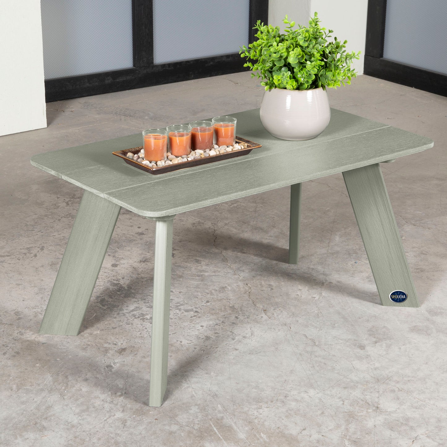 Light green Granite Hills coffee table with candles and plant