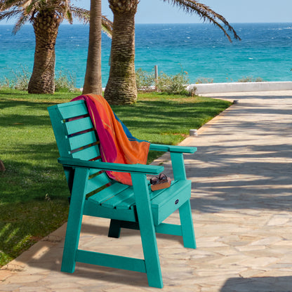 Blue Sunrise Coast garden chair on walkway near water