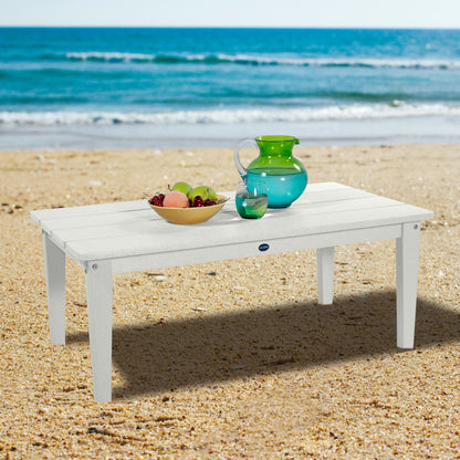 White Sunrise Coast conversation table on beach with water pitcher and fruit