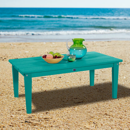 Blue Sunrise Coast conversation table on beach with water pitcher and fruit