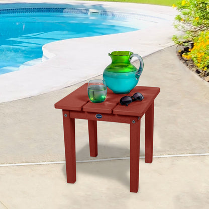 Red Sunrise Coast small side table with water and sunglasses by a pool