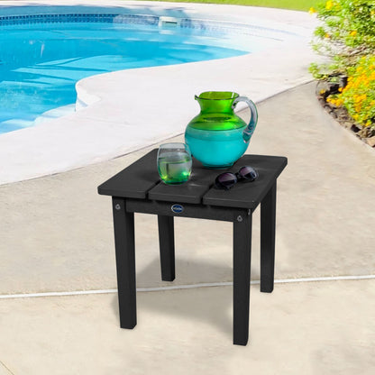 Black Sunrise Coast small side table with water and sunglasses by a pool