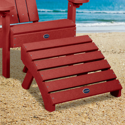 Red Sunrise Coast folding ottoman and Adirondack chair on beach