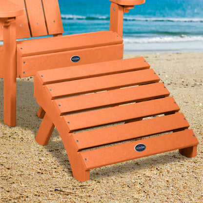 Orange Sunrise Coast folding ottoman and Adirondack chair on beach