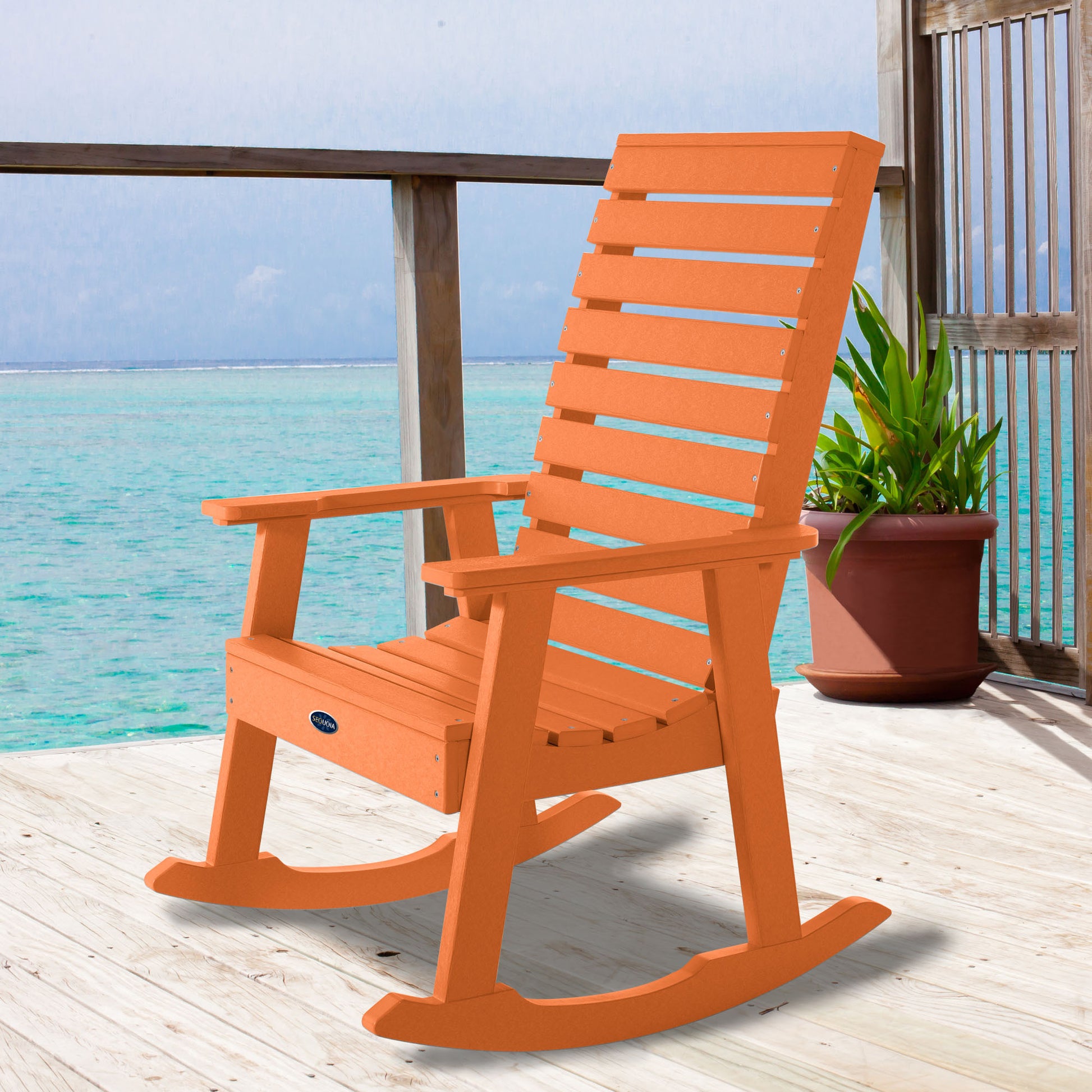 Orange Sunrise Coast rocking chair on deck overlooking water