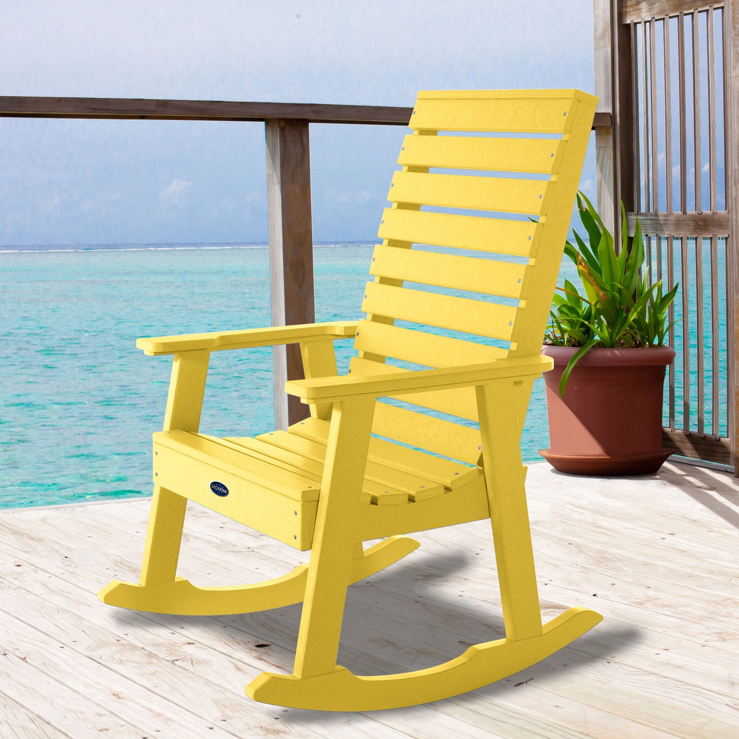 Yellow Sunrise Coast rocking chair on deck overlooking water